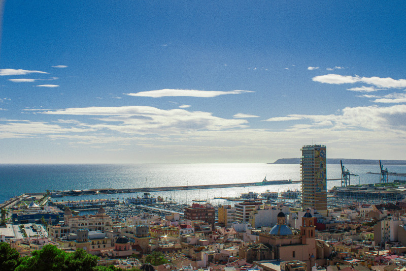 The Mediterranean Sea coastline of the Costa Blanca and Alicante city centre under a blue sky with partial white cloud on a sunny winter afternoon. Picture taken from El Parque de La Ereta – ciudad de Alicante 2026