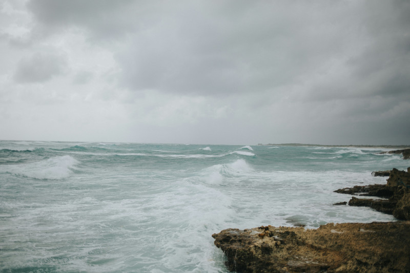 a large body of water near a rocky shore