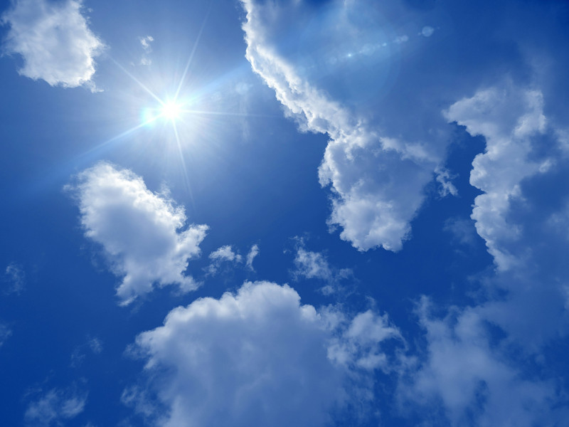 Embracing the beauty of nature as the sun peeks through the fluffy clouds, illuminating the endless blue sky. ☀️🌤️