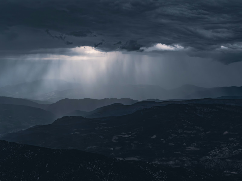 Rays of light pierce through the storm clouds.