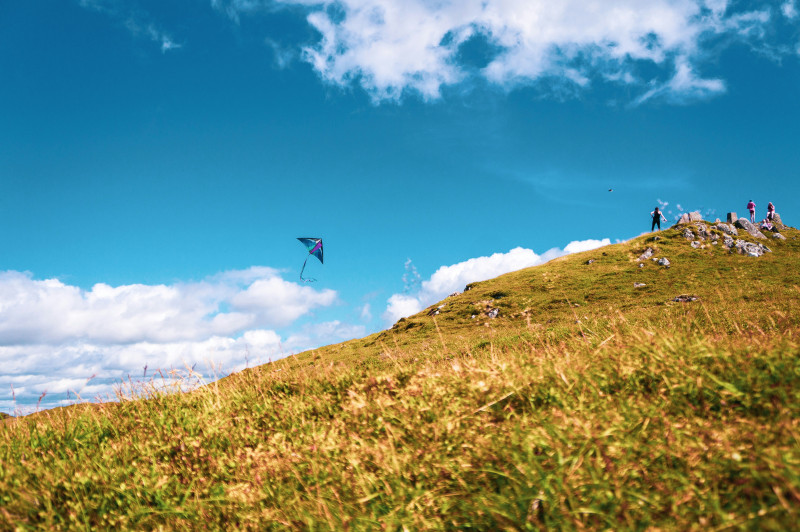 Flying a kite on a hill