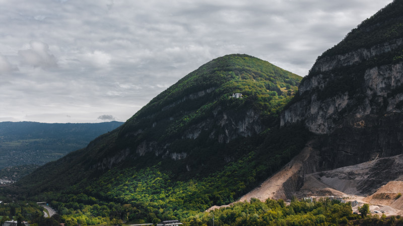 Vue à couper le souffle sur des montagnes verdoyantes à Genève avec un ciel nuageux.