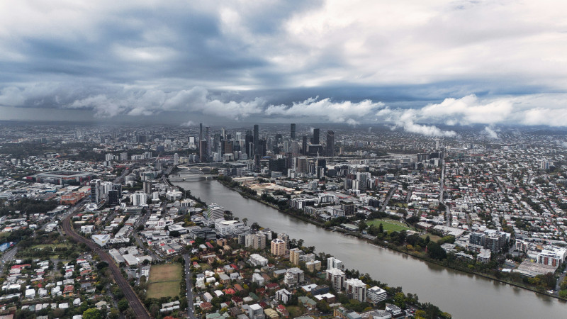City skyline with river and cloudy sky