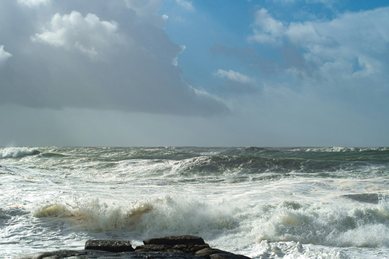 Rough ocean waves crashing on a rocky shore