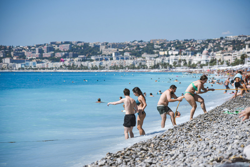 People enjoying a sunny day at a crowded beach
