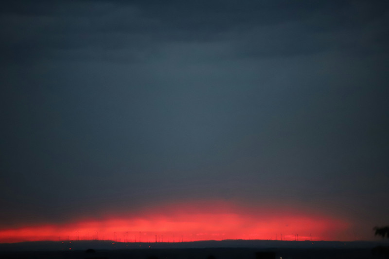 the sun is setting over the horizon of a city
