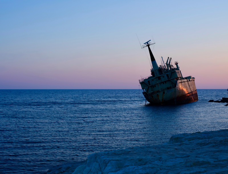 brown ship on sea under gray sky during daytime
