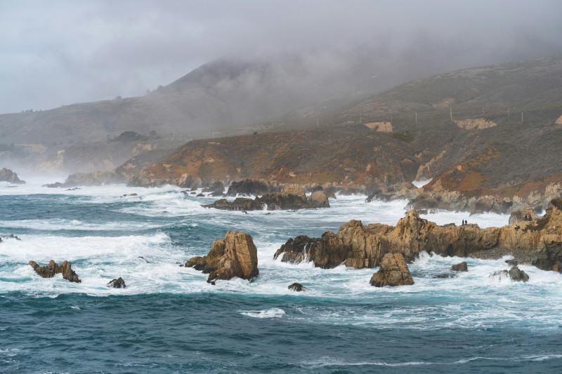 brown rock formation on sea during daytime