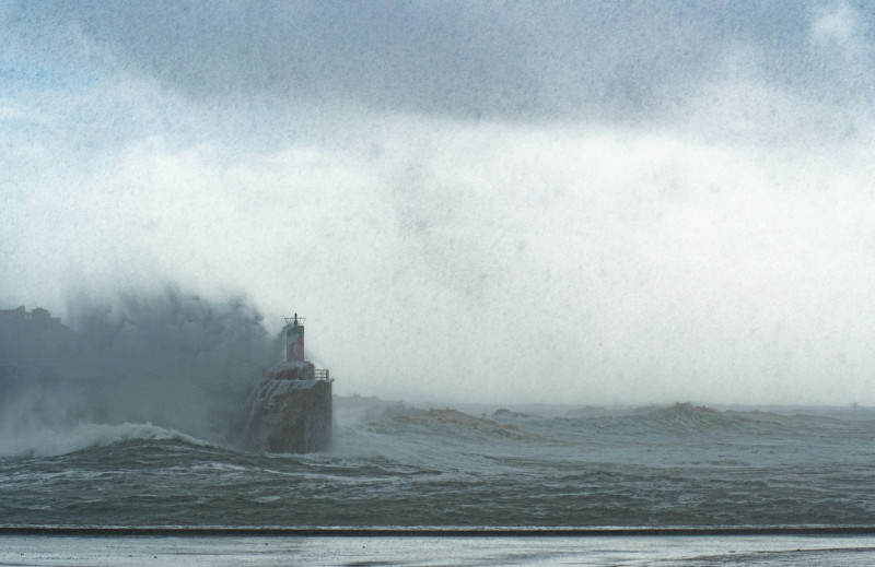 A lighthouse stands strong against stormy seas