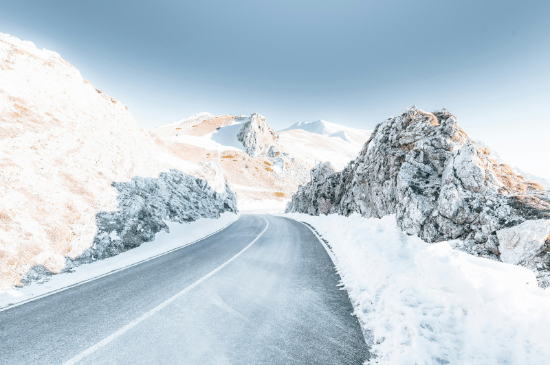 A snowy mountain road under a clear sky